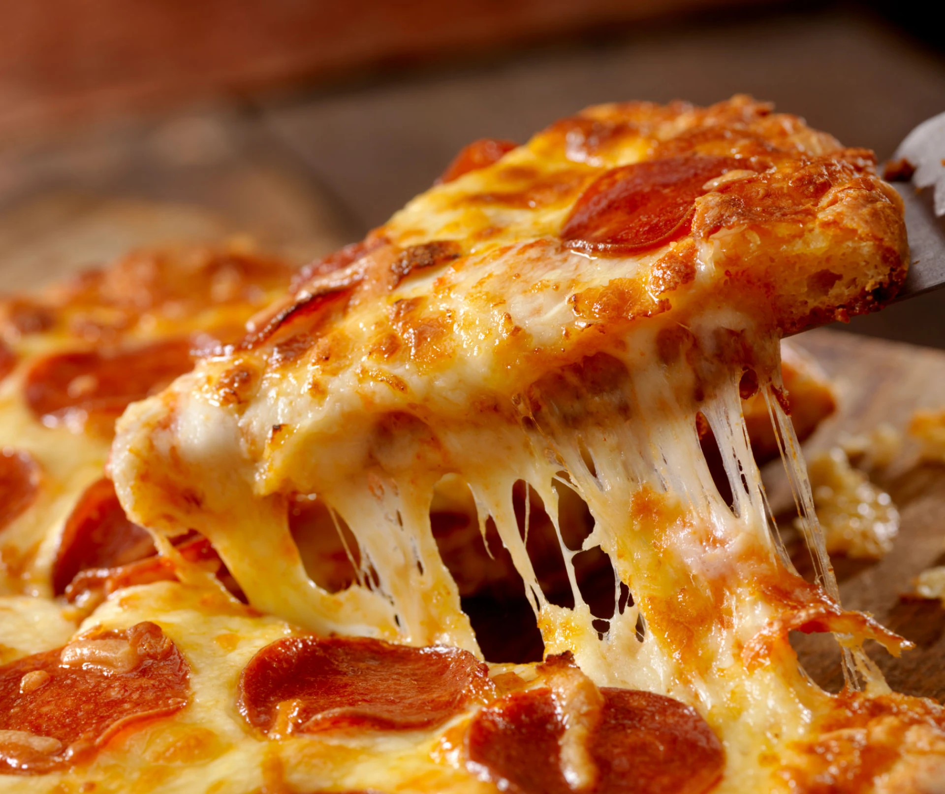 Close-up of a cheesy pepperoni pizza slice